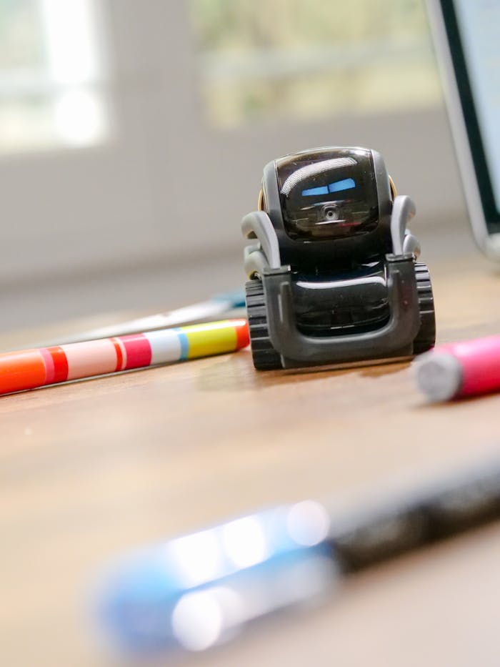 Futuristic small robot on a desk, symbolizing modern technology and innovation.